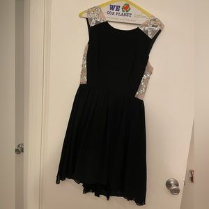 Formal knee length dress. Sheer on the sides with jewel details